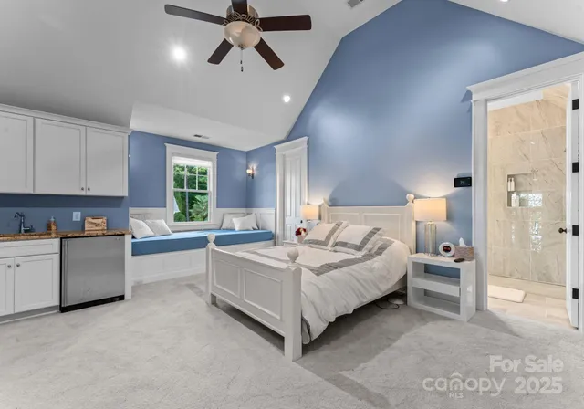 a view of a white house next to a yard with big trees