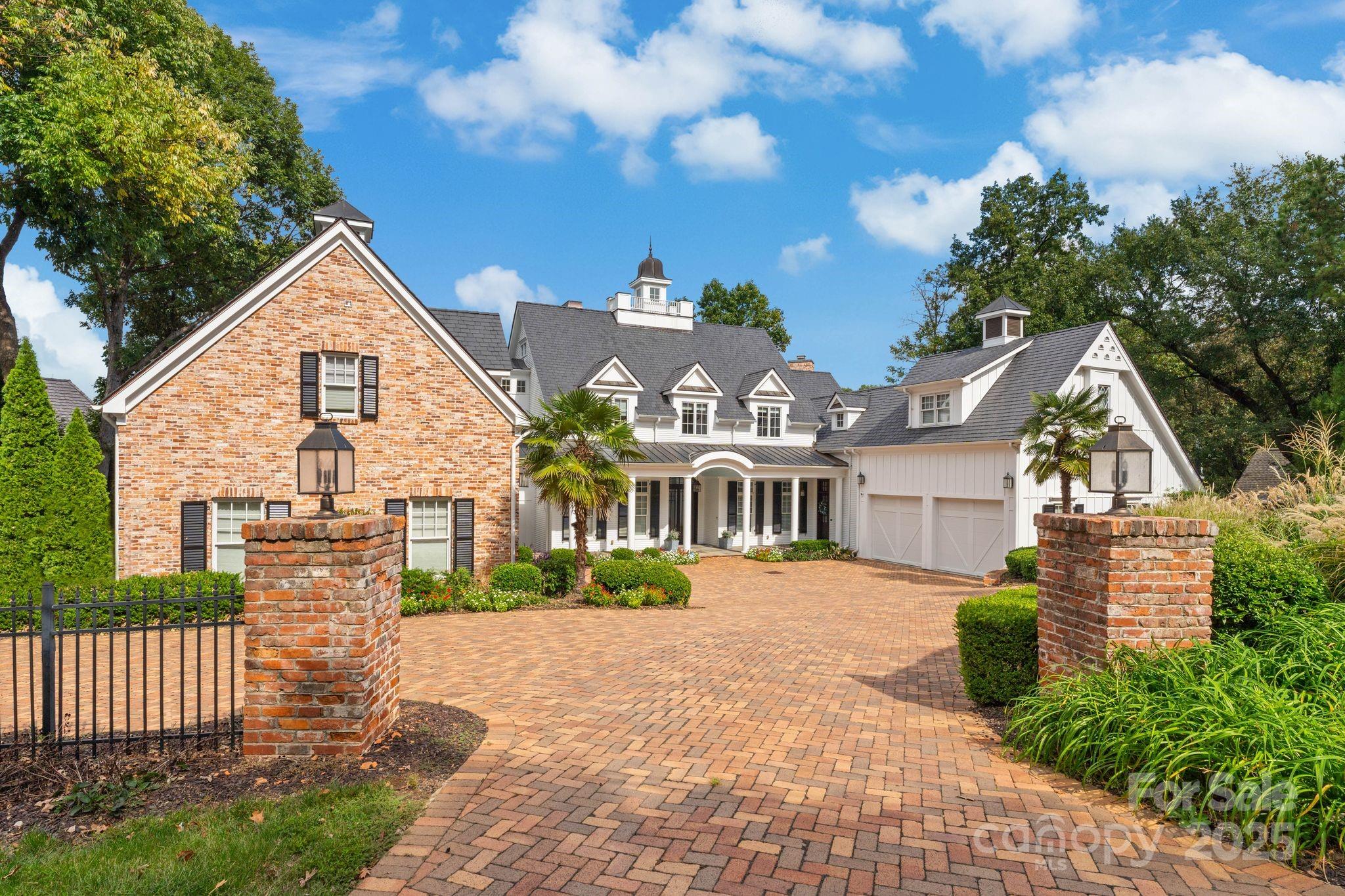 16921 Jetton Road Cornelius, NC 28031 - Photo 40 of 46 a view of a white house next to a yard with big trees