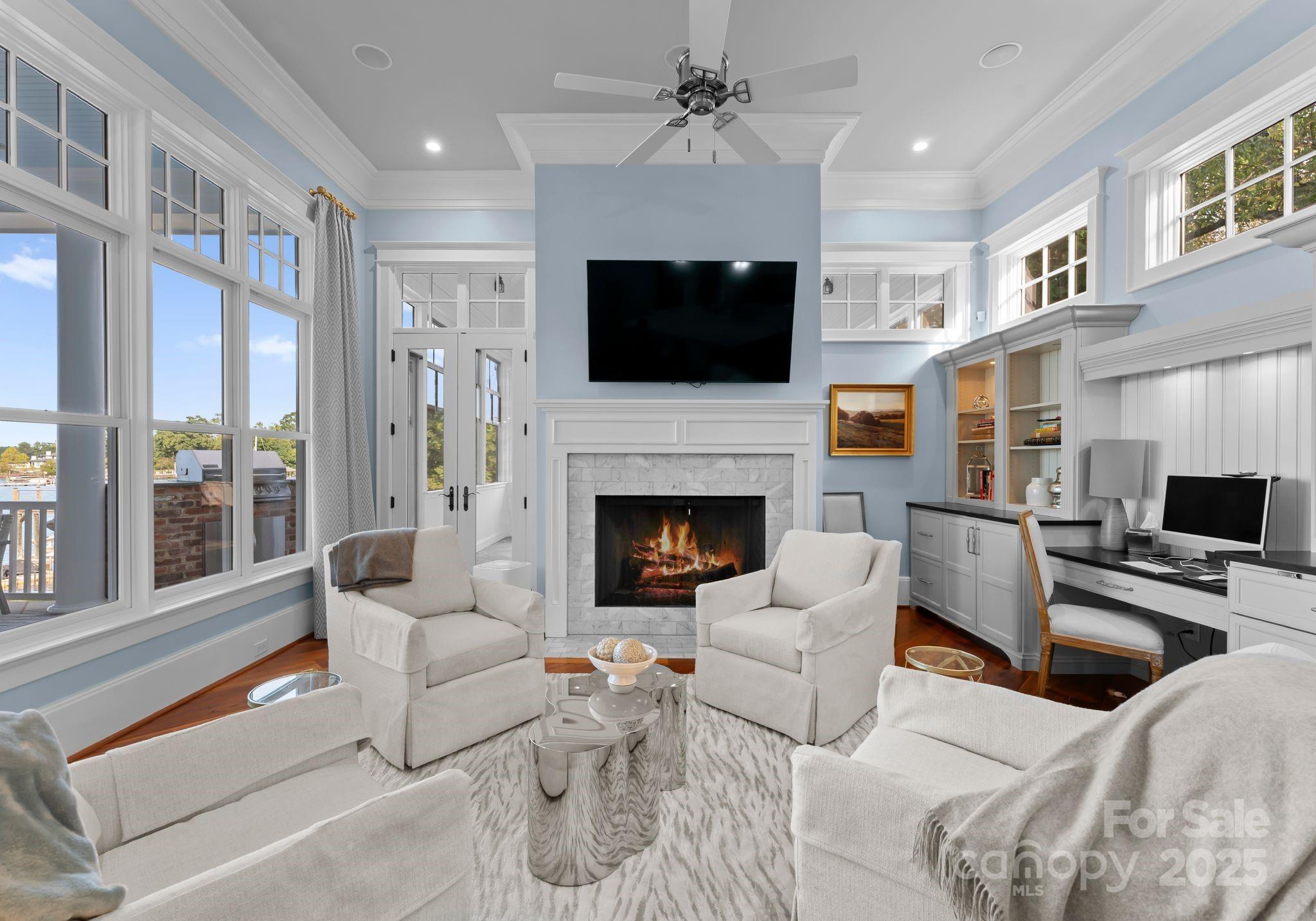 16921 Jetton Road Cornelius, NC 28031 - Photo 10 of 46 a living room with furniture a flat screen tv and a fireplace