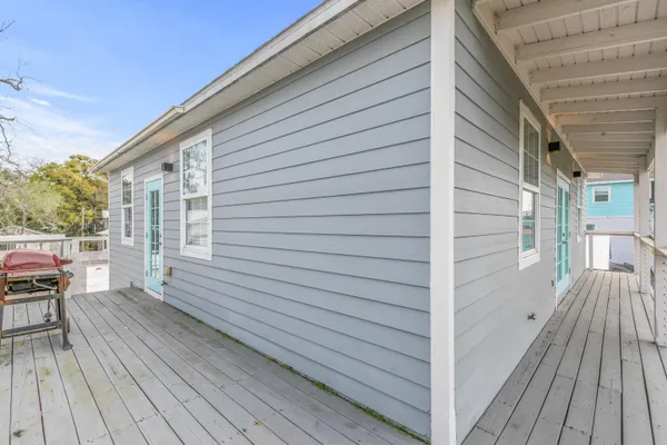 a living room with furniture a large window and a flat screen tv