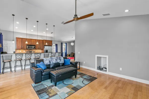 a living room with furniture and a wooden floor