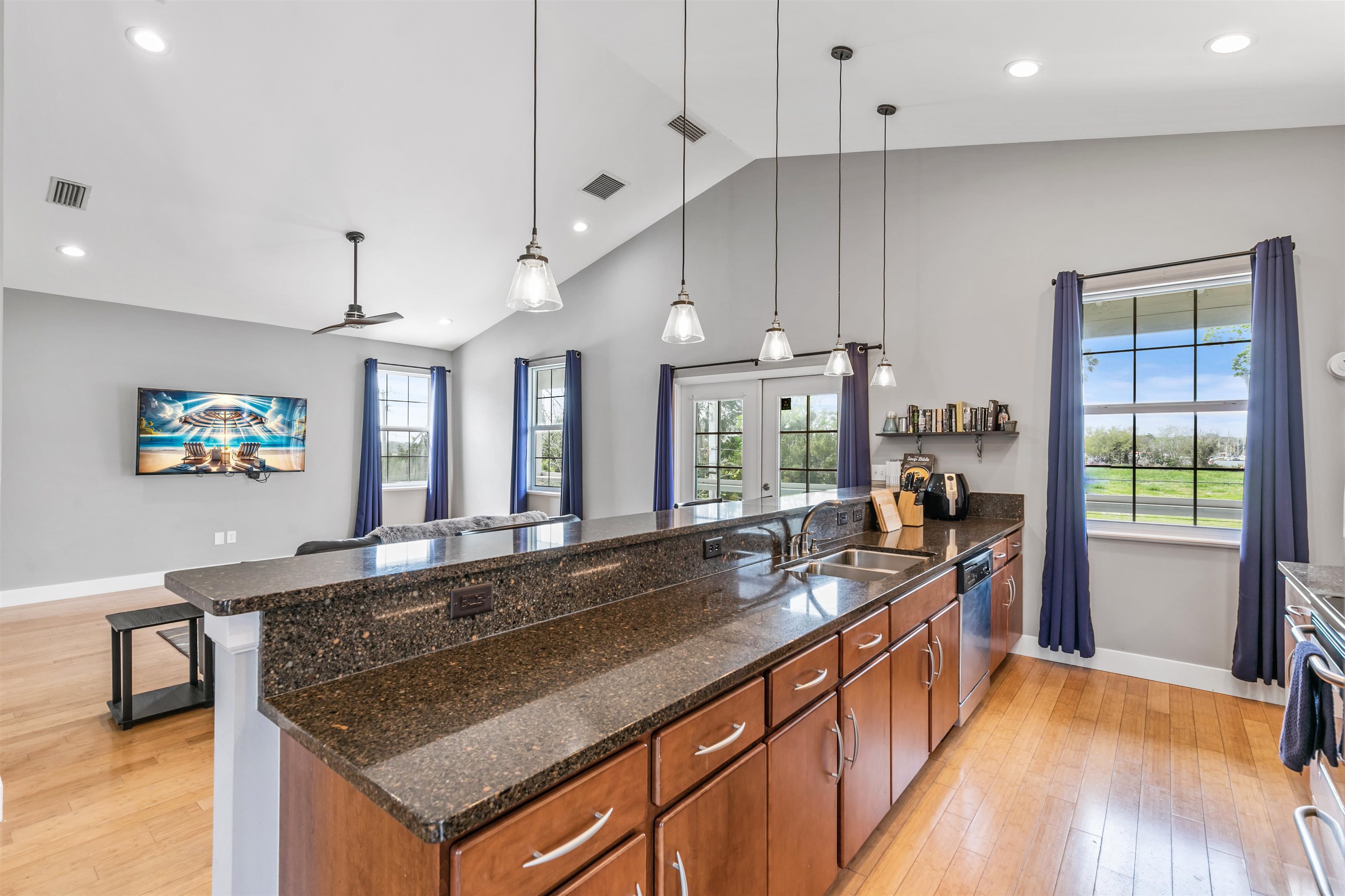 28 Spring Street St. Augustine, FL 32084 - Photo 20 of 36 a kitchen with stainless steel appliances granite countertop a sink a stove and a wooden floors