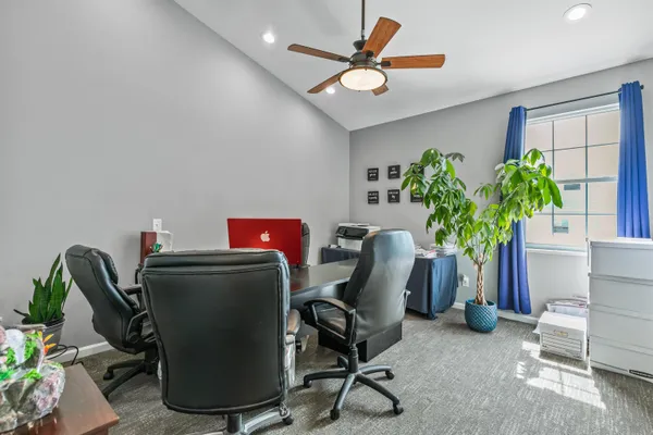 a workspace with furniture and a potted plant
