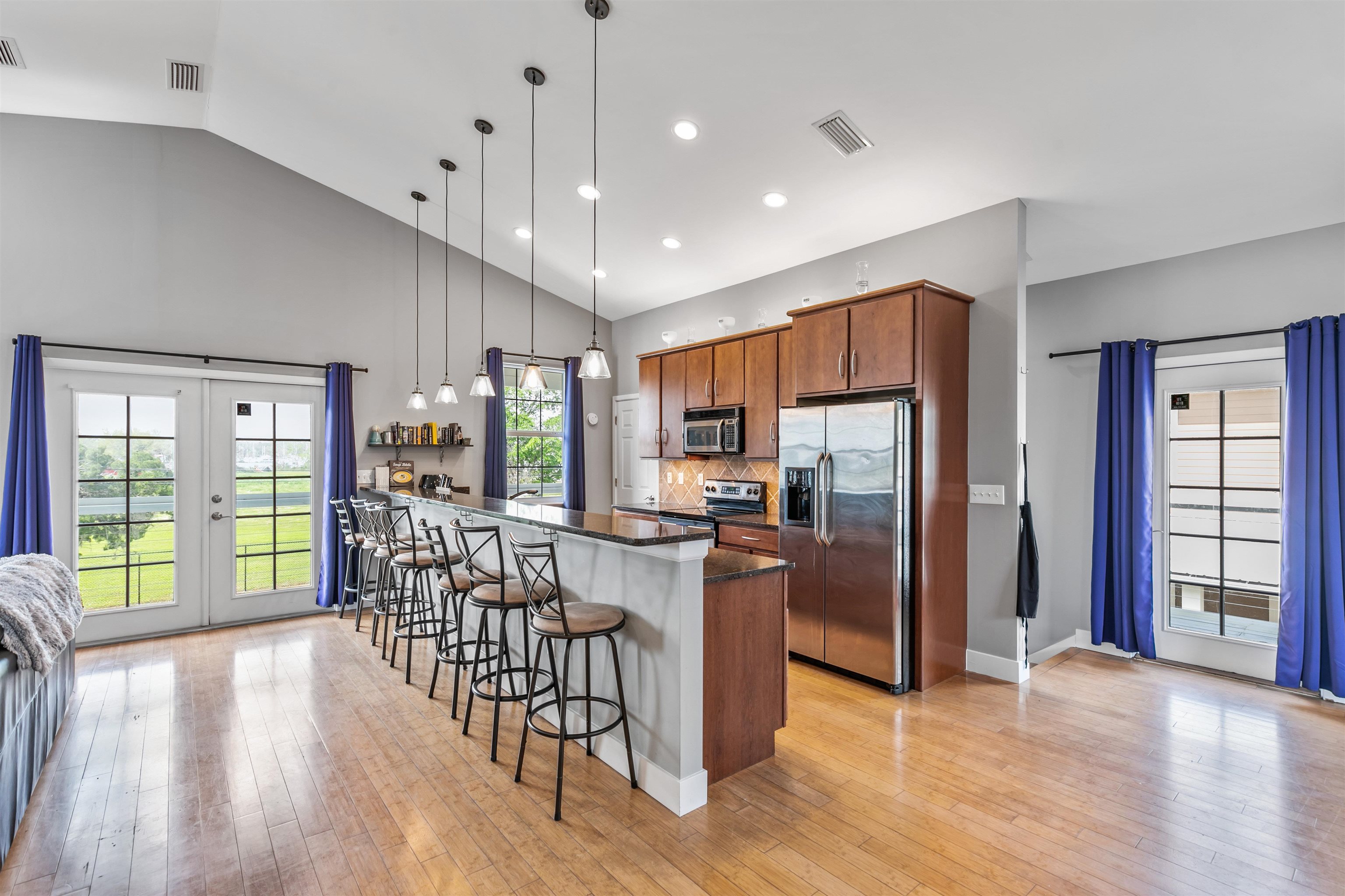 28 Spring Street St. Augustine, FL 32084 - Photo 22 of 36 a kitchen with stainless steel appliances granite countertop a refrigerator oven stove top oven with a dining table and chairs