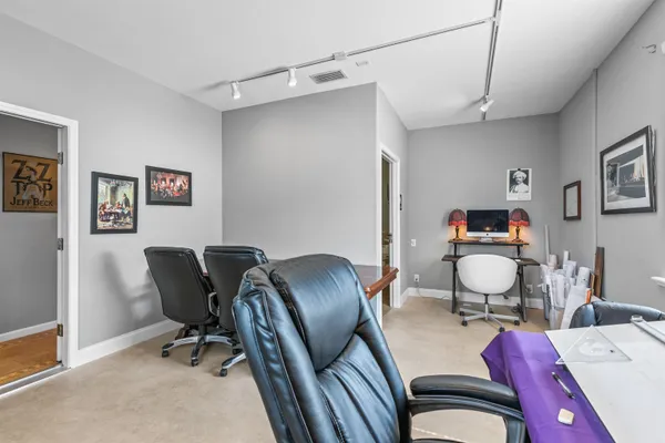 a kitchen with stainless steel appliances granite countertop a refrigerator oven stove top oven with a dining table and chairs