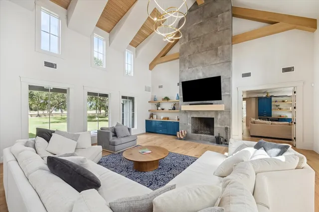 a living room with fireplace furniture and a flat screen tv