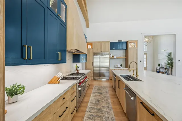 a kitchen with granite countertop a sink stove and cabinets