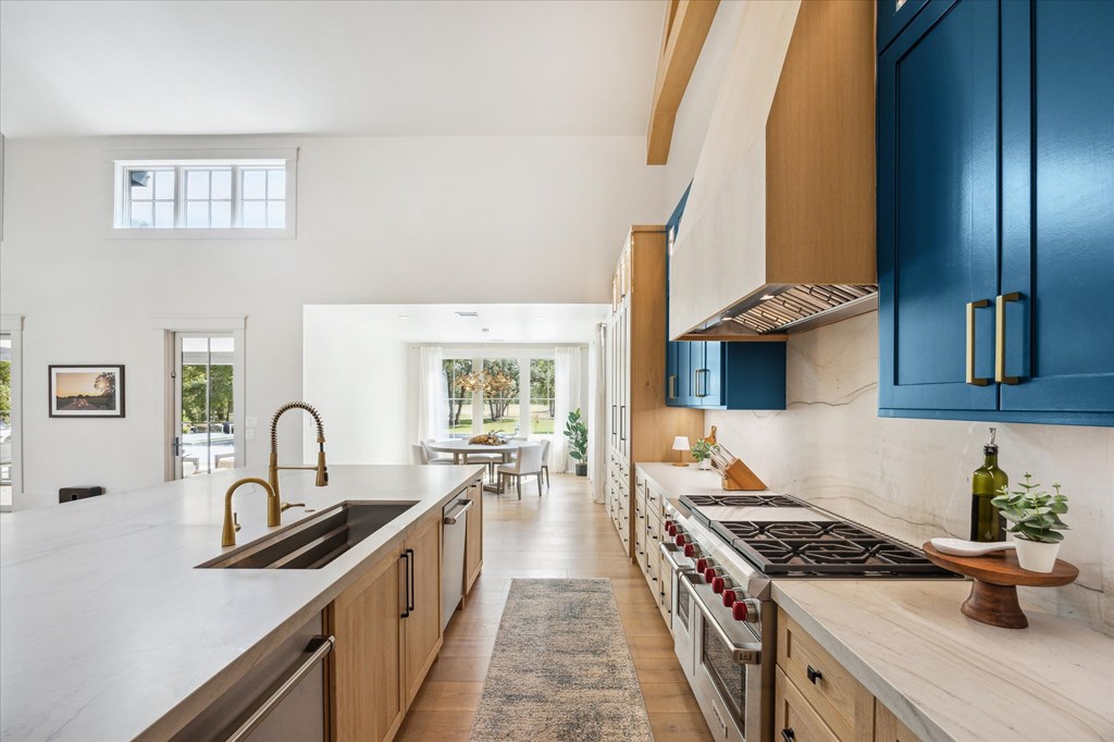 1301 County Road 218 Weimar, TX 78962 - Photo 13 of 55 a kitchen with granite countertop a sink stove and cabinets