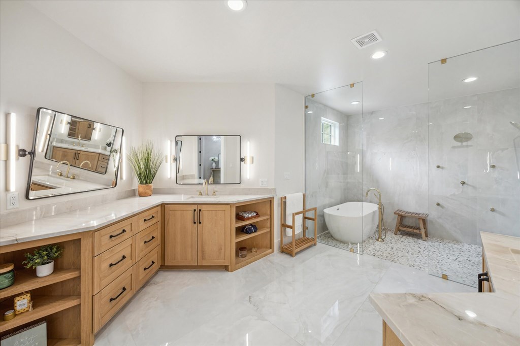 1301 County Road 218 Weimar, TX 78962 - Photo 24 of 55 a spacious bathroom with a granite countertop sink a toilet a mirror and vanity