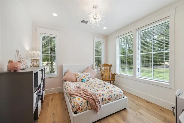 a bedroom with a large bed and a window