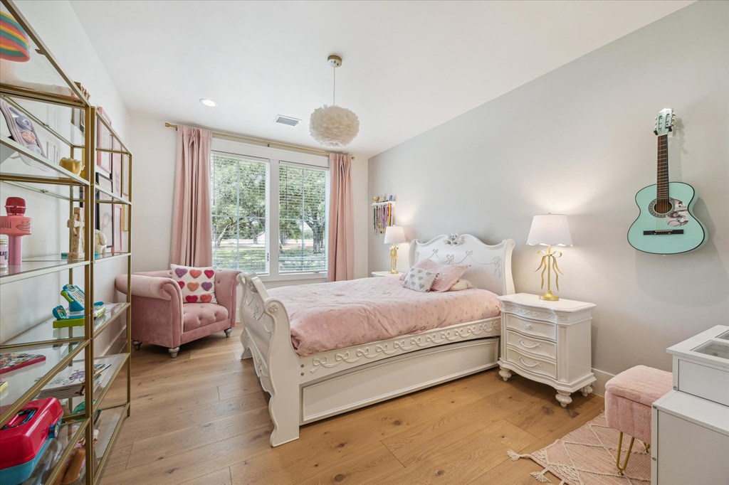 1301 County Road 218 Weimar, TX 78962 - Photo 32 of 55 a bedroom with a bed and a chandelier