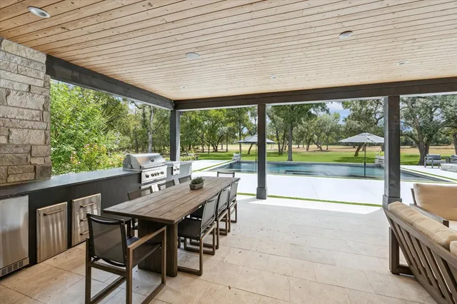 a view of a patio with a table chairs and a backyard