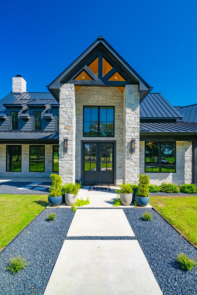 1301 County Road 218 Weimar, TX 78962 - Photo 4 of 55 a front view of a house with garden