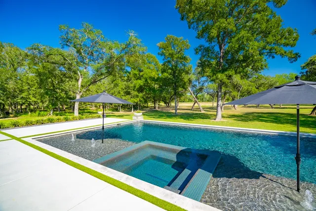 a view of a swimming pool with an outdoor space and seating area