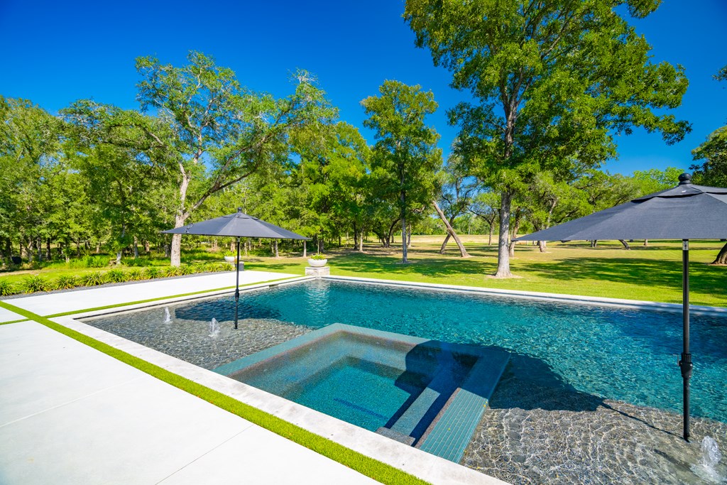 1301 County Road 218 Weimar, TX 78962 - Photo 42 of 55 a view of a swimming pool with a yard