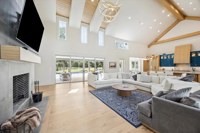 a living room with fireplace furniture and a flat screen tv