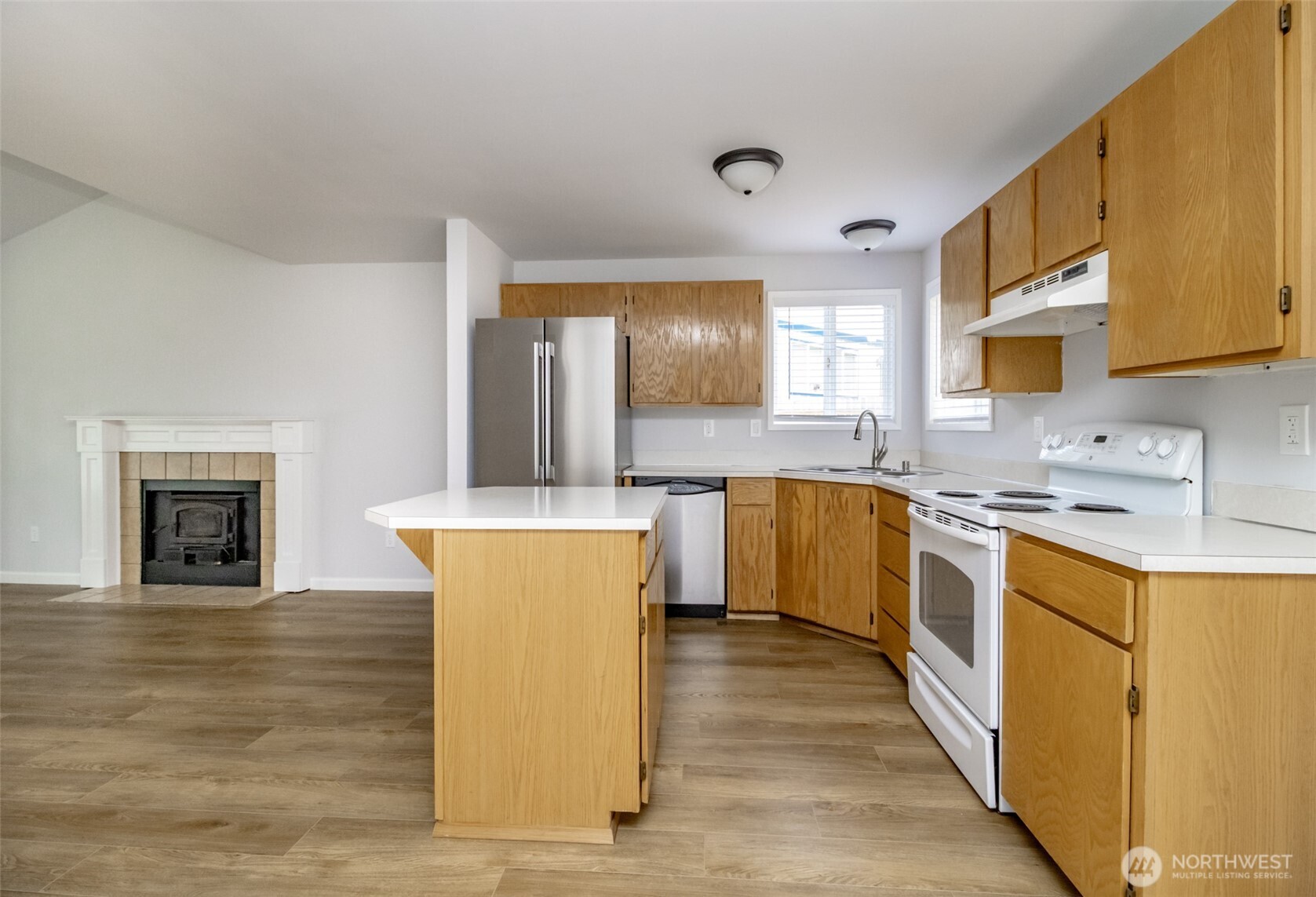 5823 186th Ave Court East, Unit A Lake Tapps, WA 98391 - Photo 11 of 27 a kitchen with a sink cabinets and wooden floor