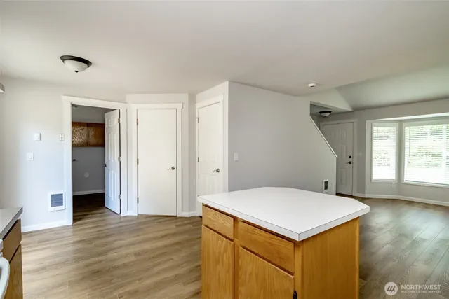 a view of entryway and hall with wooden floor