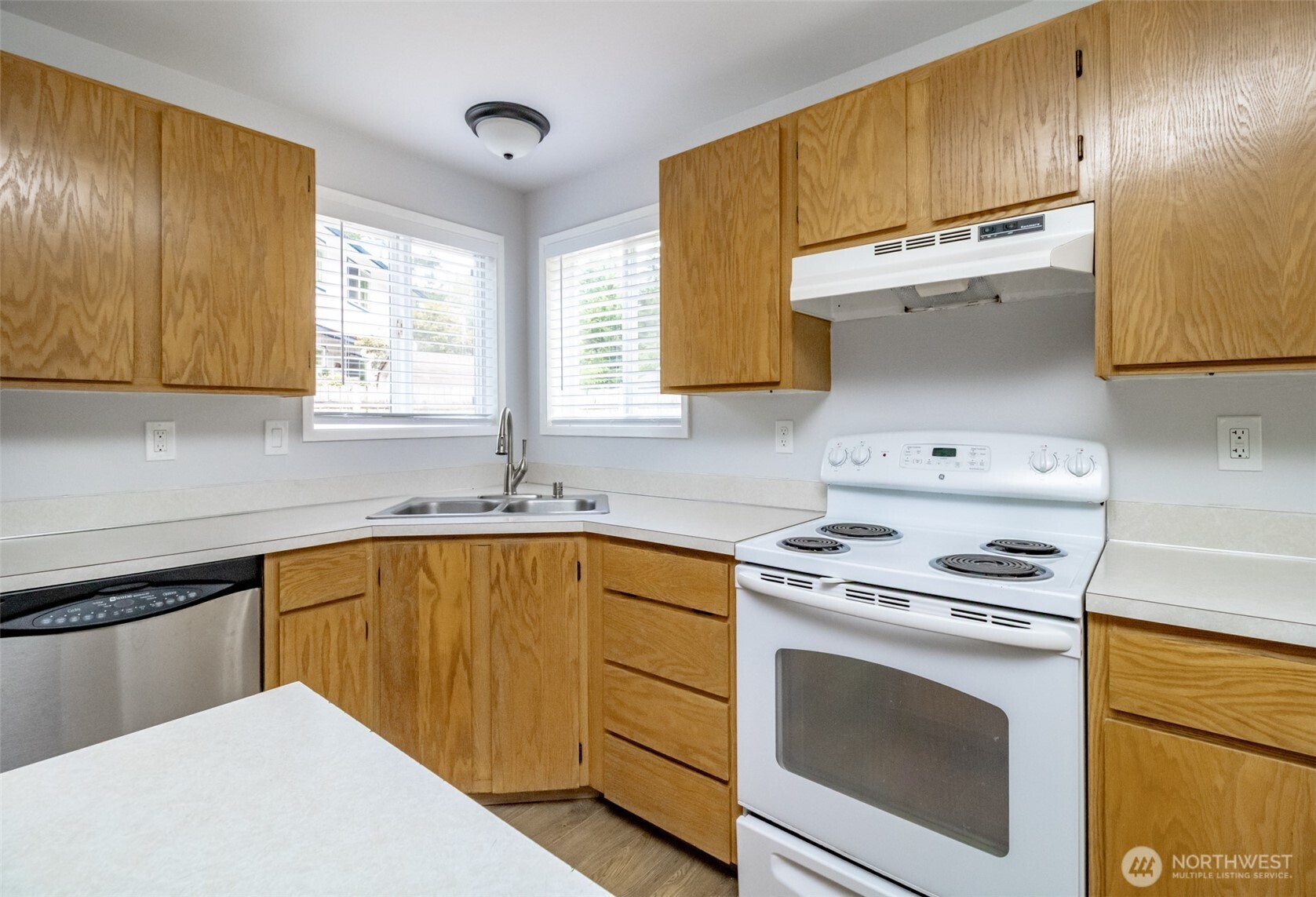 5823 186th Ave Court East, Unit A Lake Tapps, WA 98391 - Photo 14 of 27 a kitchen with a sink stove and cabinets