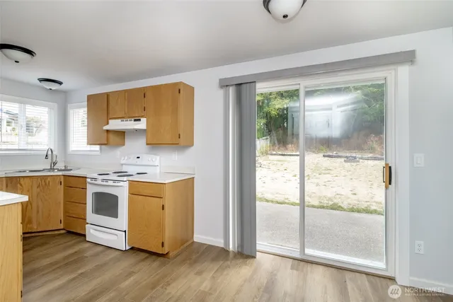 a kitchen with a stove a sink and a refrigerator