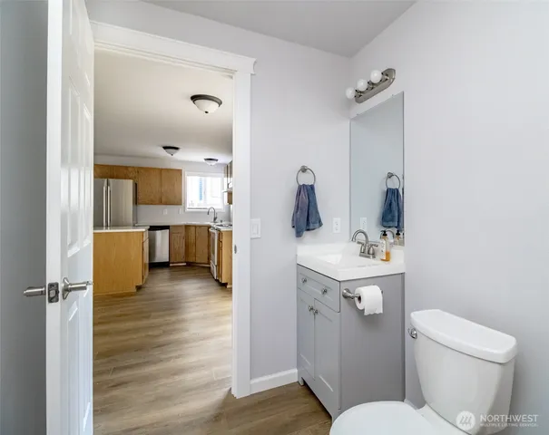 a bathroom with a sink toilet and mirror