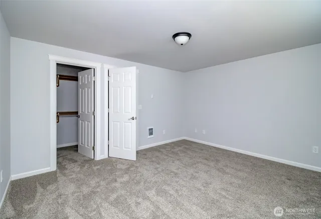 an empty room with closet area