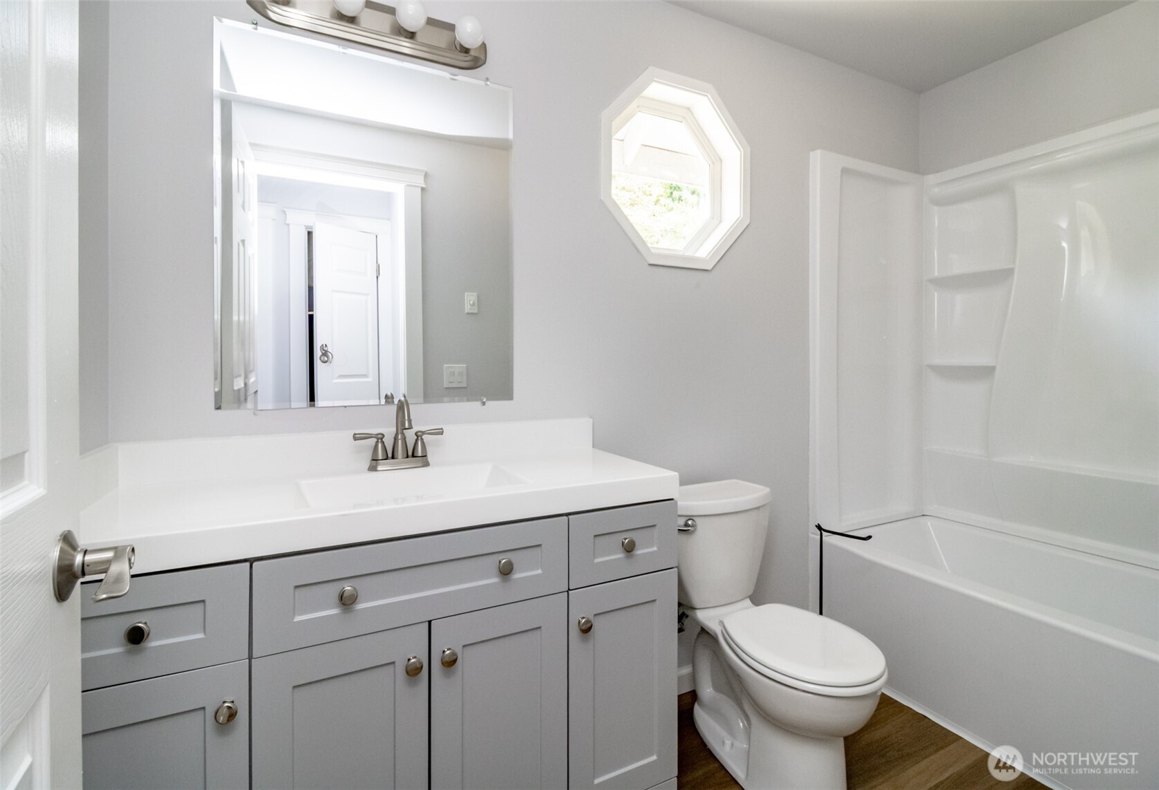 5823 186th Ave Court East, Unit A Lake Tapps, WA 98391 - Photo 24 of 27 a bathroom with a toilet a sink and mirror