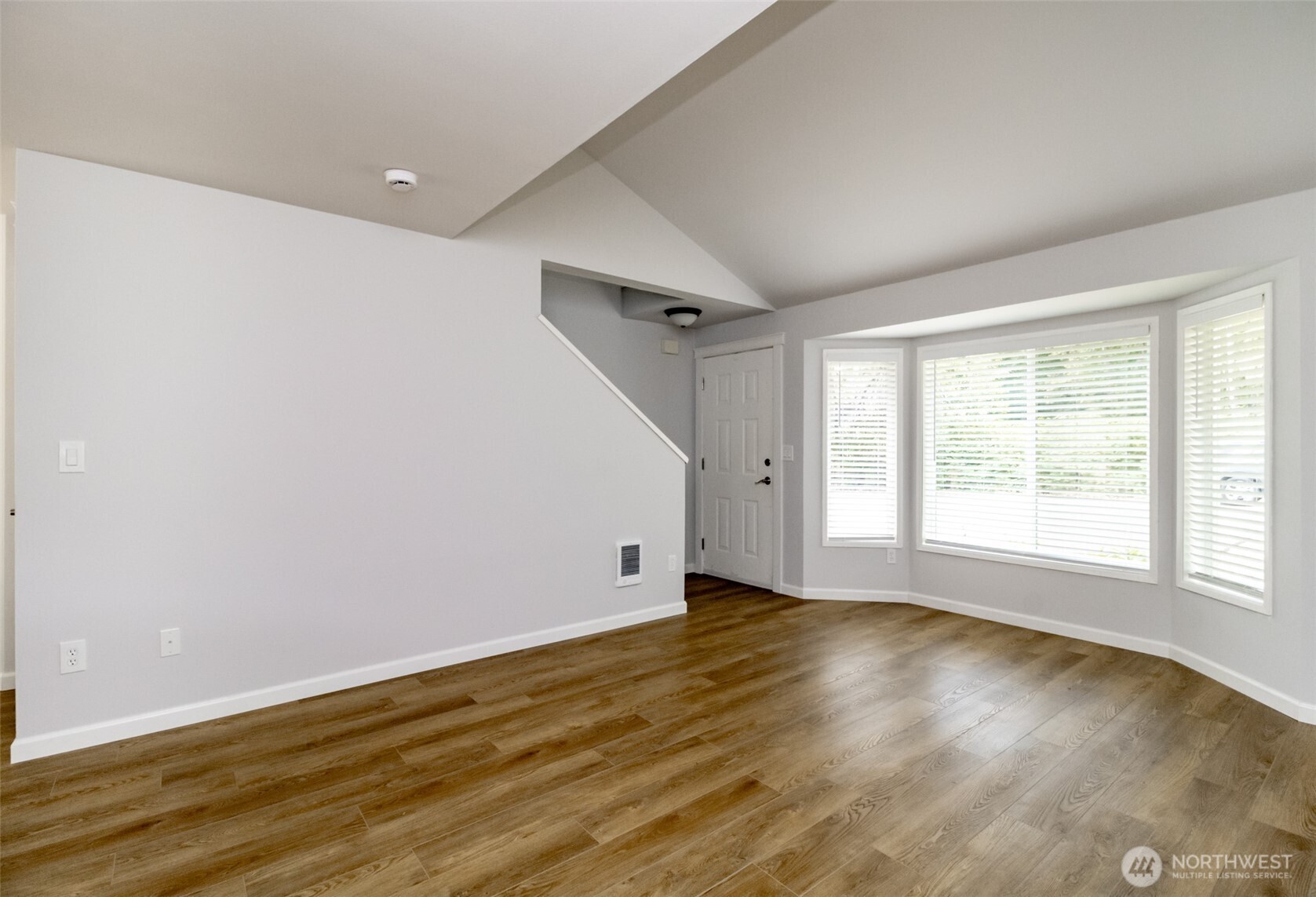 5823 186th Ave Court East, Unit A Lake Tapps, WA 98391 - Photo 7 of 27 a view of an empty room with wooden floor and a window