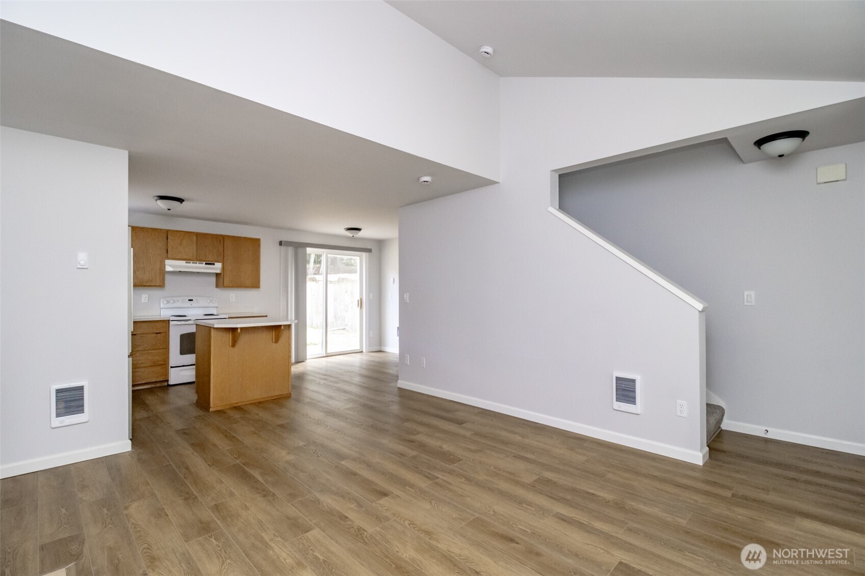 5823 186th Ave Court East, Unit A Lake Tapps, WA 98391 - Photo 8 of 27 a view of an empty room with window and wooden floor