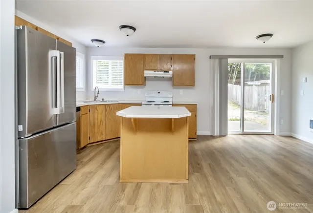 a spacious bathroom with a tub sink shower and mirror