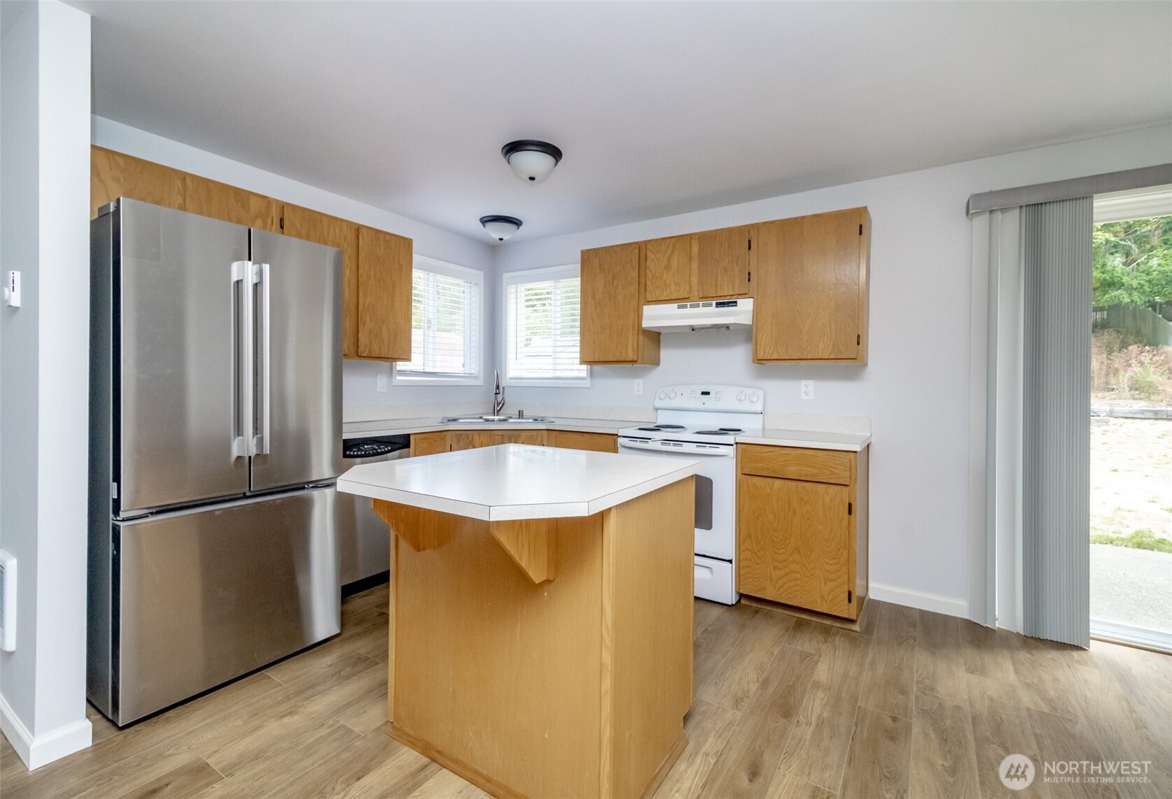 5823 186th Ave Court East, Unit A Lake Tapps, WA 98391 - Photo 10 of 27 a kitchen with kitchen island granite countertop a sink appliances cabinets and a counter top space