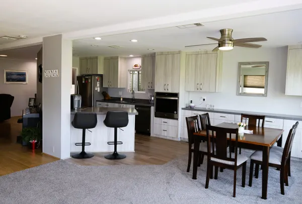 a view of kitchen with furniture and a potted plant