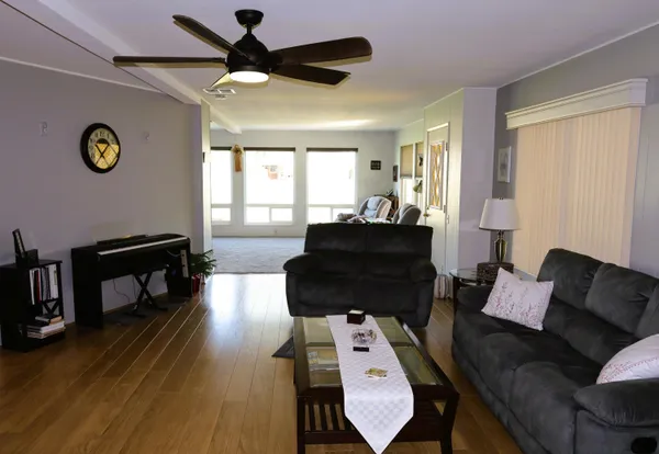 a living room with furniture and a wooden floor