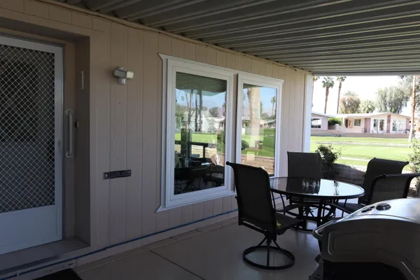 a dining room with furniture window and outside view