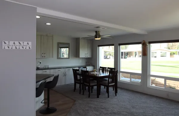a view of a dining room with furniture and a window