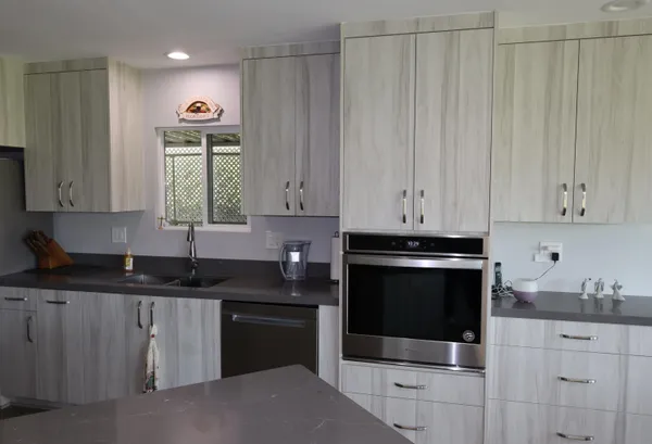 a kitchen with granite countertop white cabinets and sink