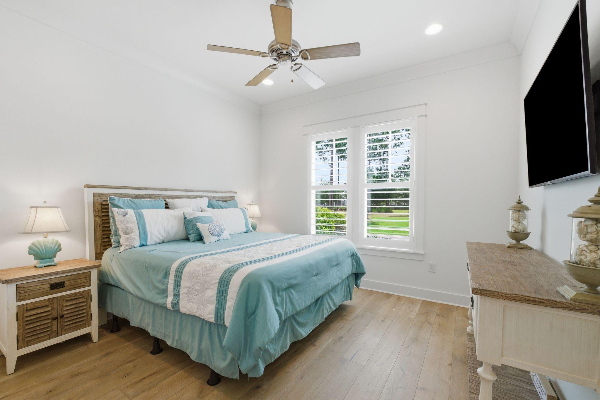 133 Sandchase Circle, Unit LOT 15 Inlet Beach, FL 32461 - Photo 20 of 47 a bedroom with a bed and a flat screen tv