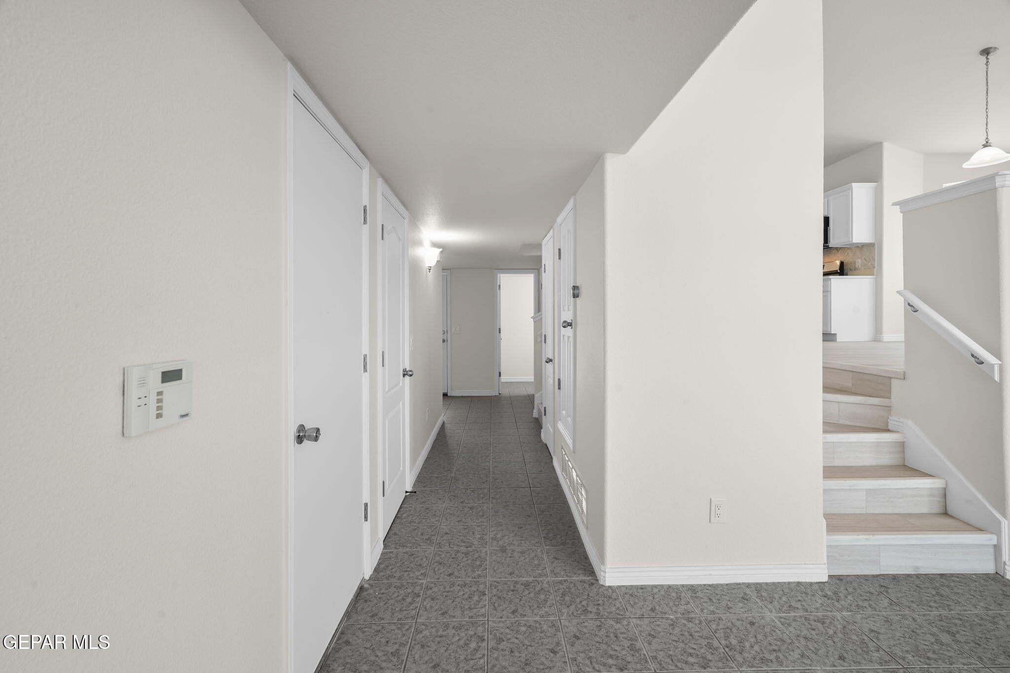 3657 Sammy Reece PIace El Paso, TX 79938 - Photo 8 of 56 a view of a hallway with white walls and stairs