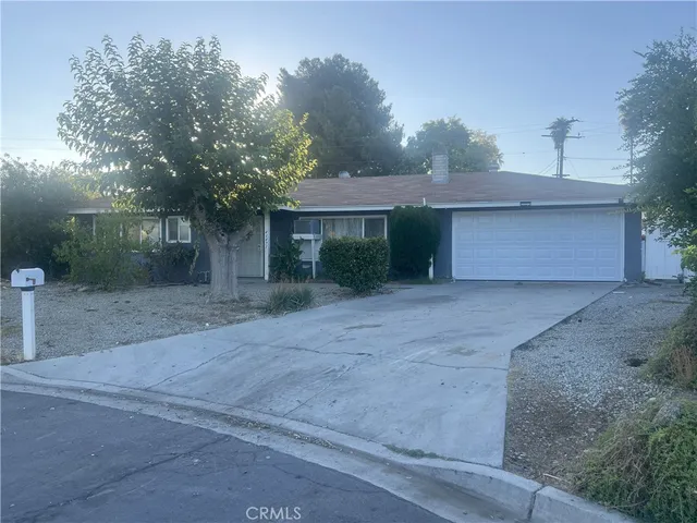 a front view of a house with a yard and a garage