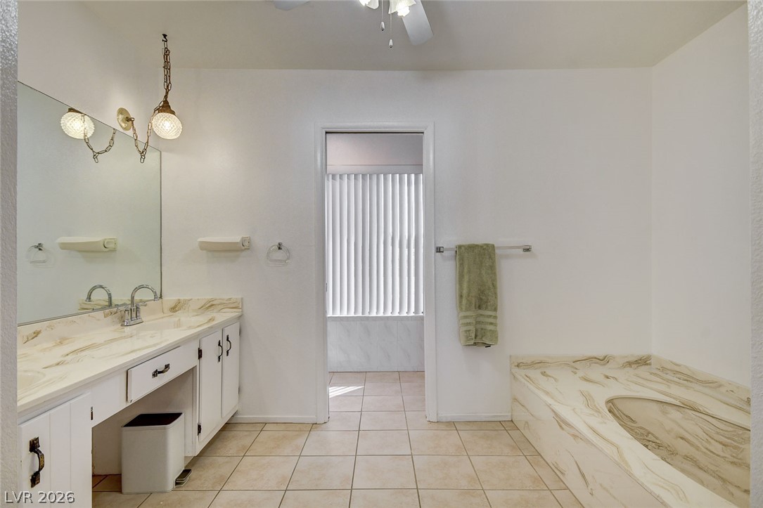 1401 Sharon Road Las Vegas, NV 89106 - Photo 57 of 73 Tiled flooring runs throughout this spacious bathroom layout featuring a built-in soaking tub.