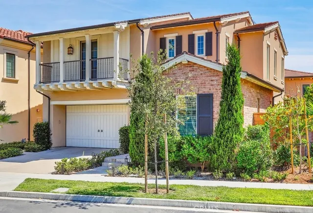 a front view of a house with a garden and plants