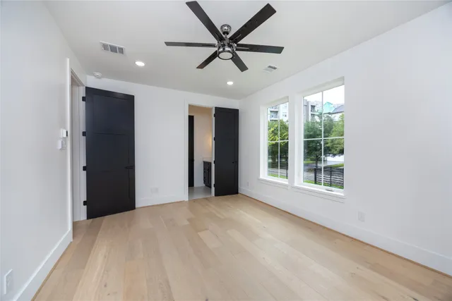 a bathroom with a double vanity sink toilet and mirror