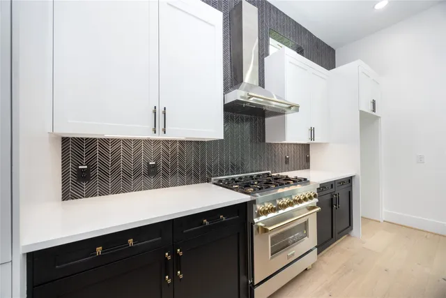 a stove top oven sitting inside of a kitchen