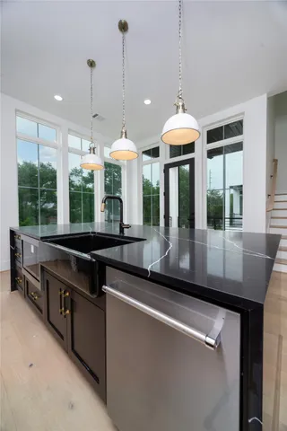 a kitchen with stainless steel appliances a stove and a chandelier