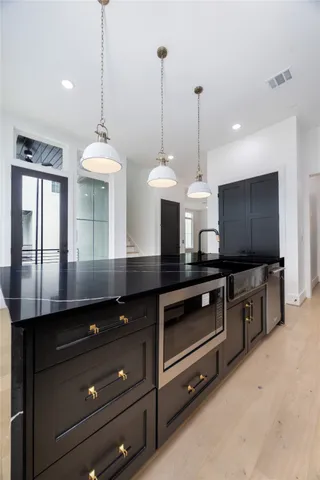 a kitchen with a stove and a large window