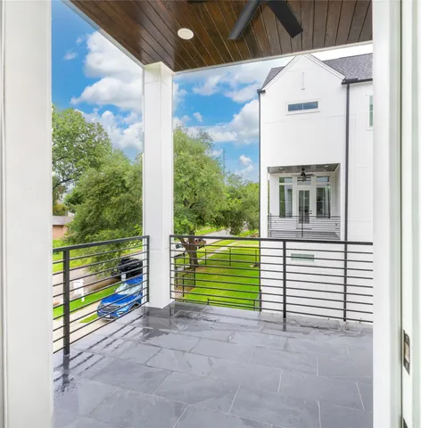 a view of an empty room with a window and a ceiling fan