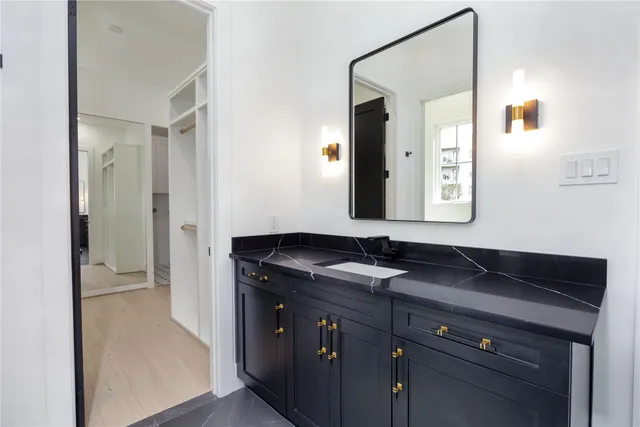a view of a hallway with wooden floor and cabinet