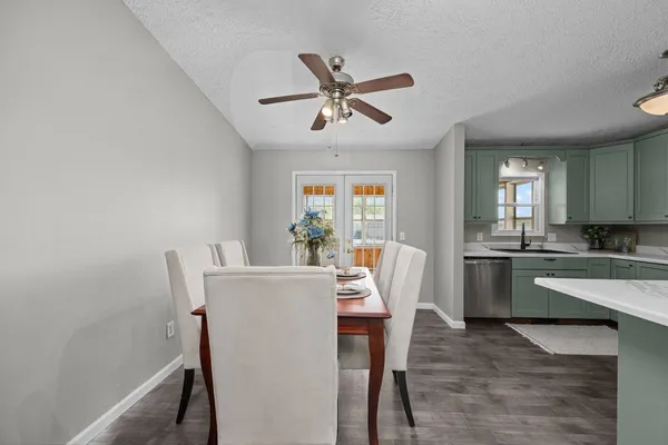 a dining room with furniture a window and wooden floor
