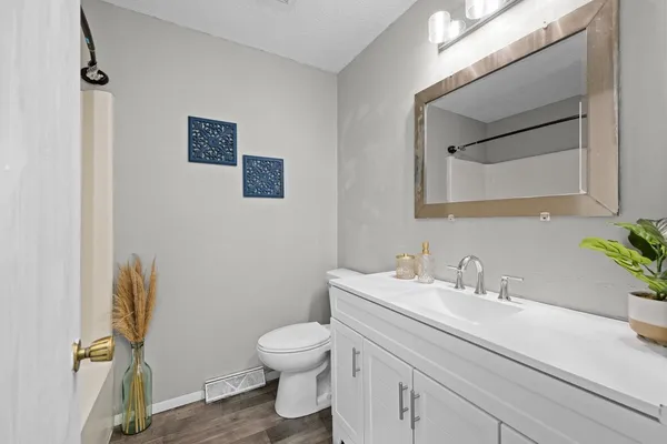 a bathroom with a sink mirror vanity and toilet