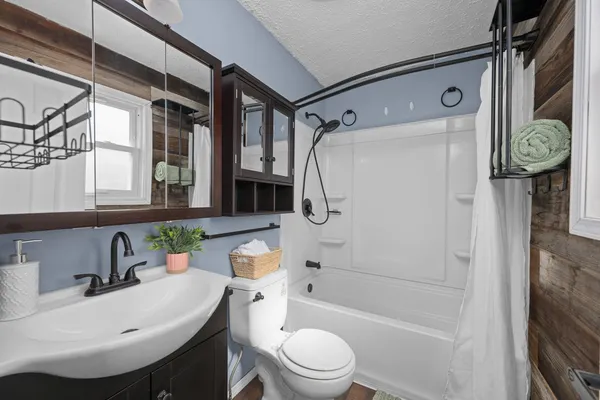 a bathroom with a sink toilet and shower
